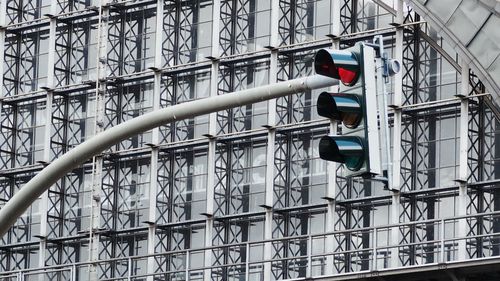 Low angle view of stoplight against building