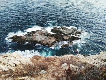 High angle view of rocks in sea