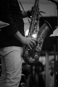 Midsection of man playing saxophone