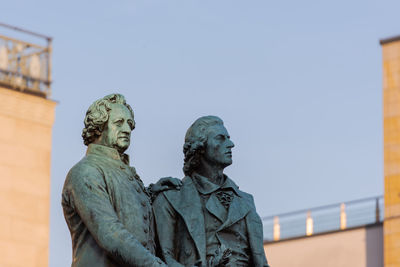 Low angle view of statue against clear blue sky