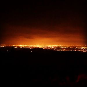 Silhouette landscape against sky at night