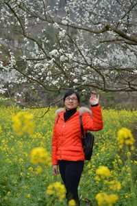 Woman standing in front of flower tree