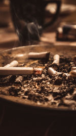 Close-up of cigarette smoking on floor