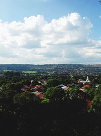 View of cityscape against cloudy sky