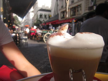 Close-up of woman holding coffee cup in cafe