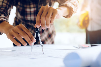 Architects working on blueprint at desk