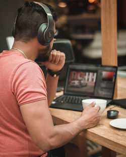 Rear view of man working on table