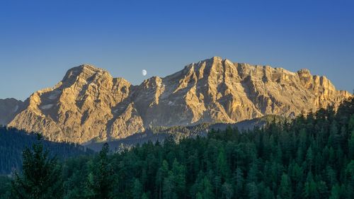 Scenic view of mountains against clear blue sky