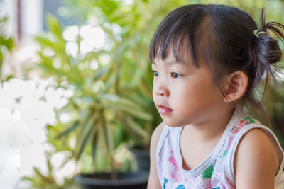 Close-up portrait of cute girl looking away