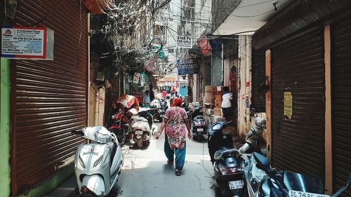 People on street amidst buildings in city