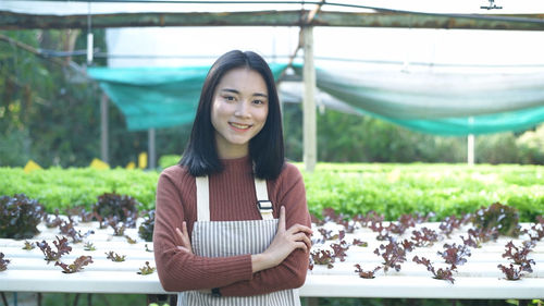 Portrait of smiling young woman standing outdoors