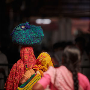 Rear view of woman with multi colored umbrella