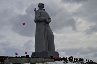 Low angle view of statue against cloudy sky