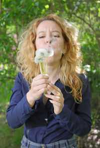 Portrait of young woman holding ice cream