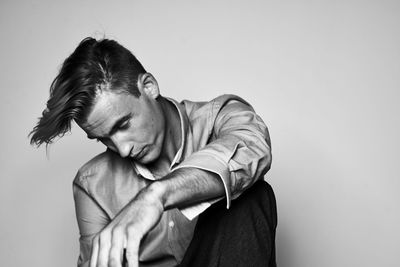 Portrait of young man against white background