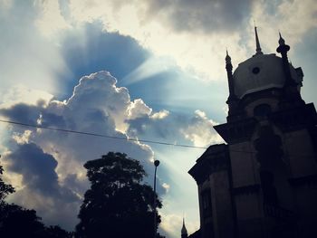 Low angle view of building against cloudy sky