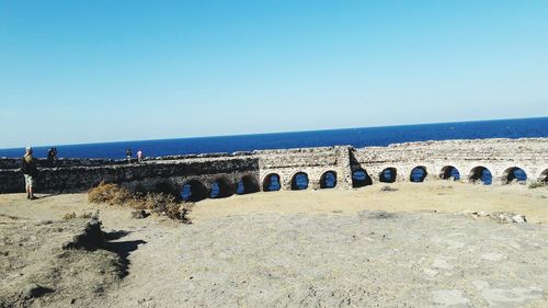 Scenic view of beach against blue sky