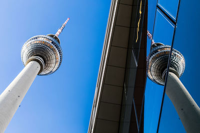 Low angle view of tower against blue sky