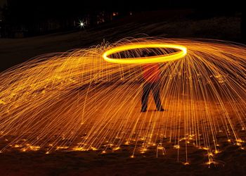 Person standing with light painting at night