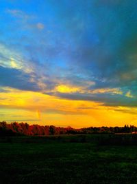 Scenic view of field against cloudy sky