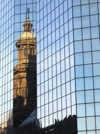 Low angle view of clock tower against sky