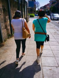 Woman walking on sidewalk