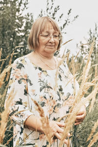 Woman with arms raised on field