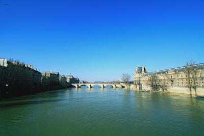 Bridge over river against blue sky