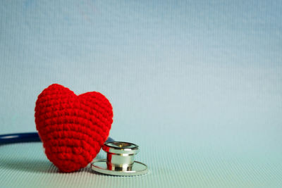 Close-up of heart shape on table against blue background