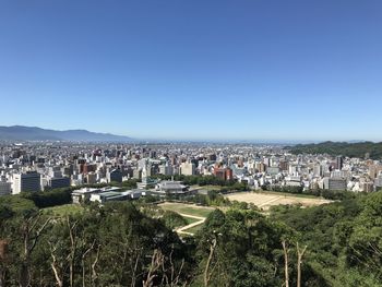High angle view of townscape against clear blue sky