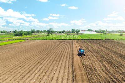 Farmer on tractor loosens and grinds the soil. preparing the land for a new crop planting. 