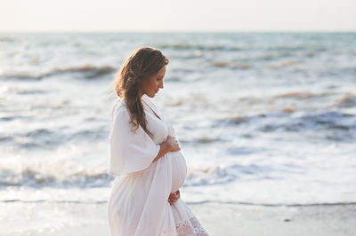 Young woman standing at beach