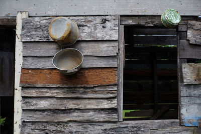 Old kitchen utensils hanging on the wall abandoned.