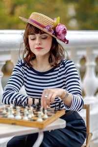 Portrait of young woman sitting on table
