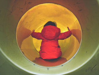 Rear view of child in tunnel