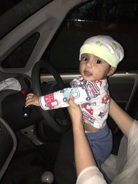 Cute girl sitting in car