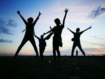 People on field against sky during sunset