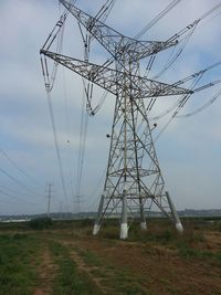 Electricity pylon on field