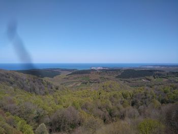 Scenic view of landscape against clear blue sky