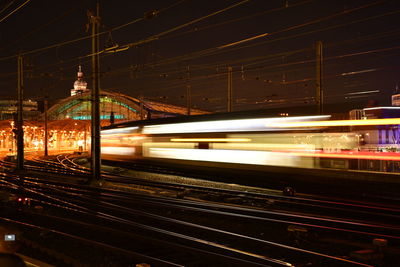 Train at railroad station platform at night