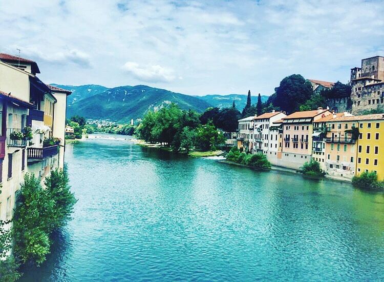 SCENIC VIEW OF RIVER AND HOUSES AGAINST SKY