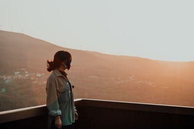 Young woman wearing mask looking away