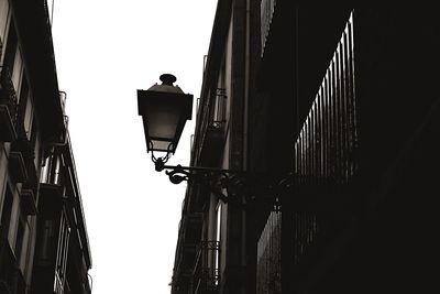 Low angle view of street light against building
