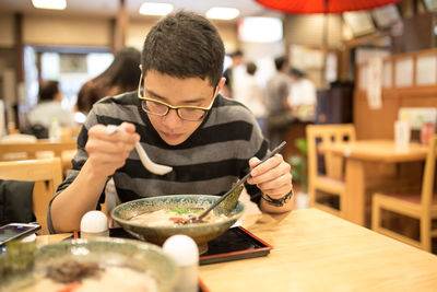 Man having meal while sitting in restaurant