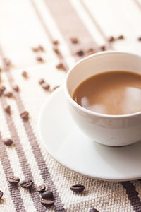 Close-up of coffee with beans on table