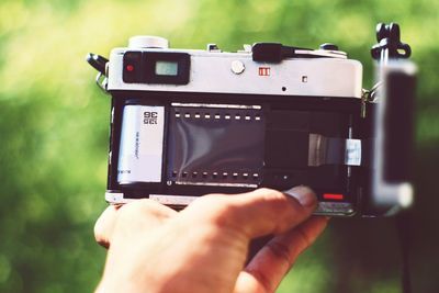 Cropped hand holding camera