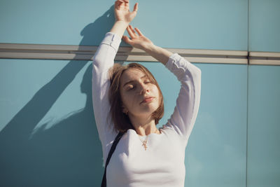 Woman amidst lens flare in city