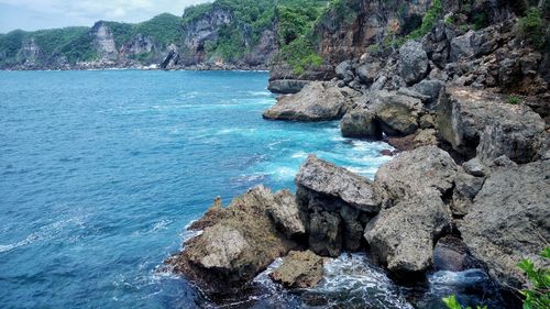 Rocks on shore by sea