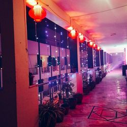 Illuminated lanterns hanging in building at night