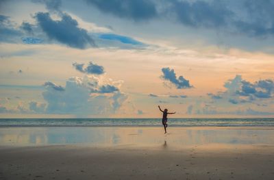 Man surfing in sea against sky